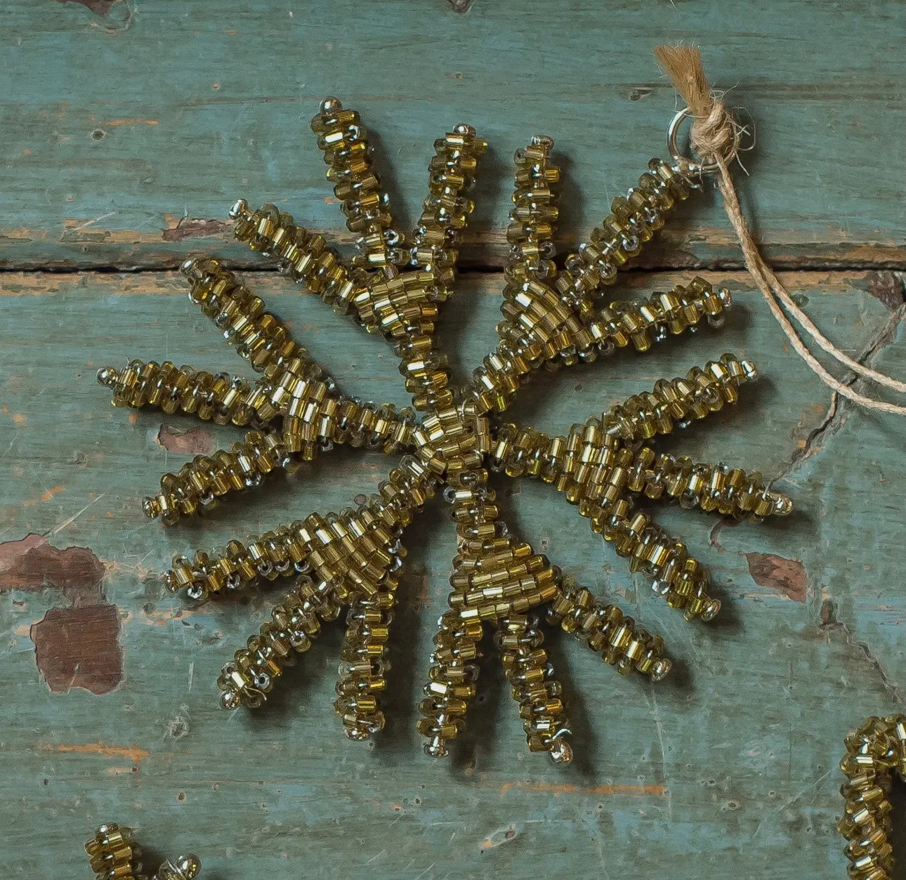 Gold beaded antique style snowflake decoration.